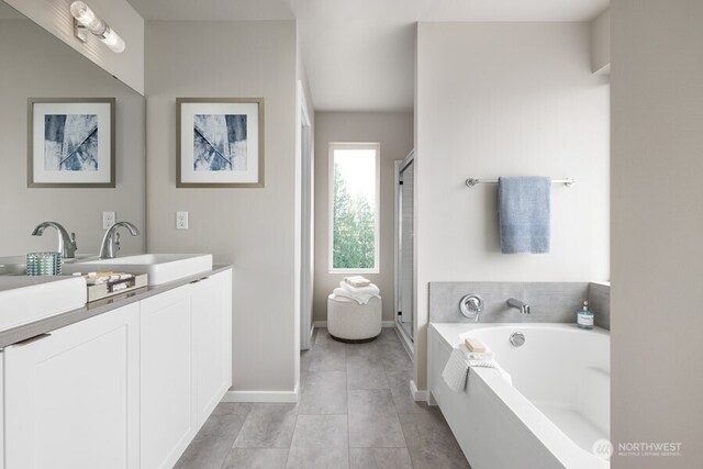 bathroom featuring tile patterned flooring, vanity, and shower with separate bathtub