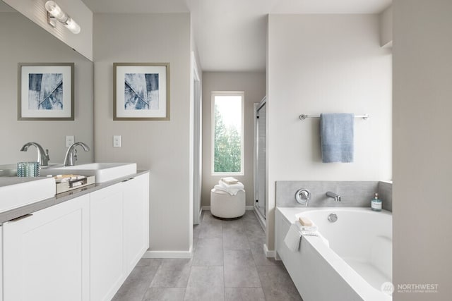 bathroom featuring vanity, tile patterned floors, and plus walk in shower