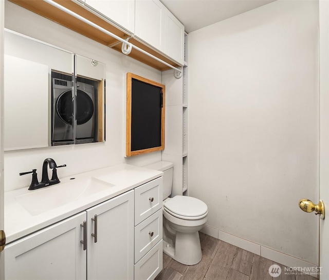 bathroom with hardwood / wood-style flooring, vanity, and toilet