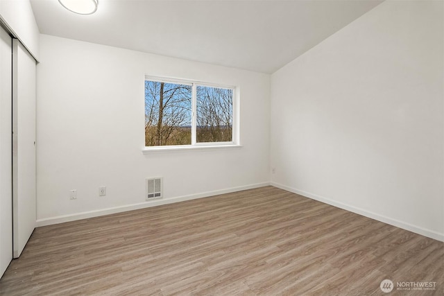 unfurnished bedroom featuring a closet and light hardwood / wood-style flooring