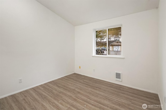 spare room featuring wood-type flooring