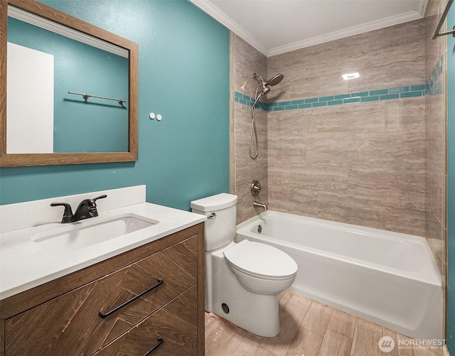 full bathroom featuring ornamental molding, toilet, vanity, and tiled shower / bath