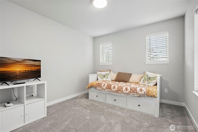 bedroom with carpet flooring and baseboards