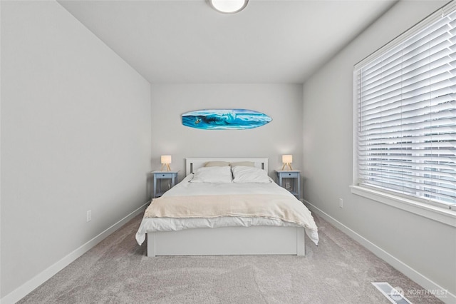 bedroom featuring carpet floors, visible vents, and baseboards