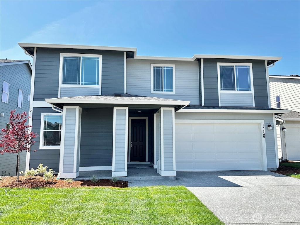 13420 187th Street Ct E Unit 21, Puyallup, WA 98374 - view of front of property with driveway, an attached garage, and a front lawn