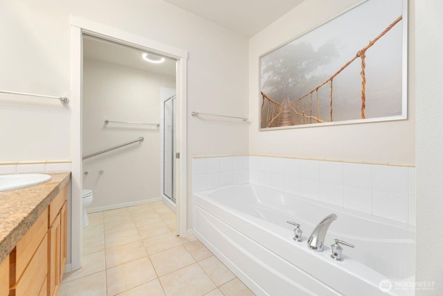 bathroom featuring a garden tub, toilet, a stall shower, tile patterned flooring, and vanity