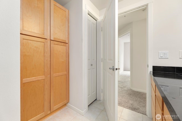 bathroom featuring baseboards and tile patterned flooring