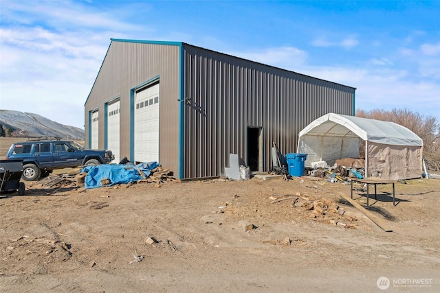 view of outdoor structure with a mountain view and a garage