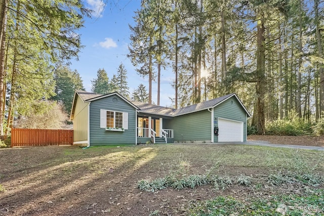 ranch-style home featuring aphalt driveway, fence, and a garage