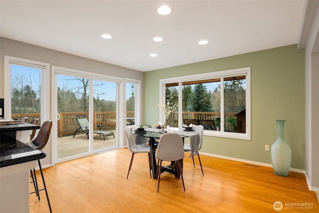 dining area with light hardwood / wood-style floors