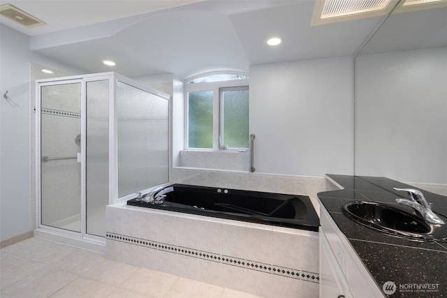 bathroom with independent shower and bath, vanity, and tile patterned flooring