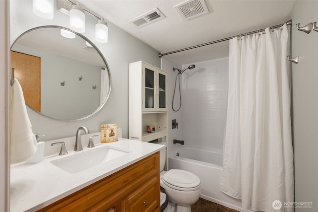 full bathroom featuring vanity, a textured ceiling, toilet, and shower / bath combo