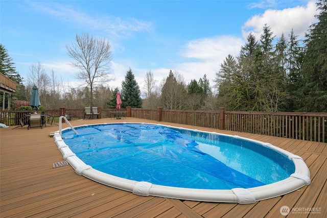 view of swimming pool featuring a wooden deck