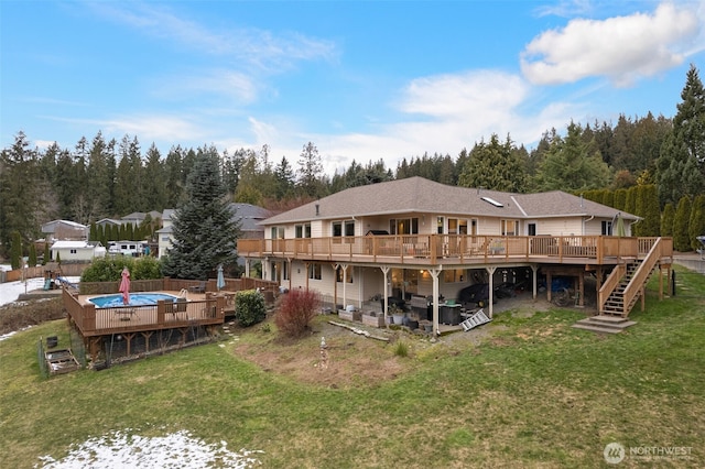 back of property featuring a wooden deck and a lawn