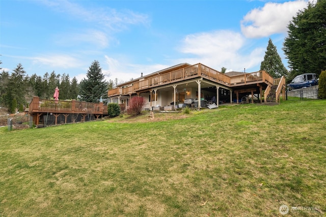 back of house featuring a yard and a deck