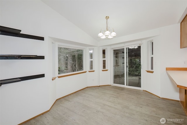 unfurnished dining area featuring lofted ceiling, light hardwood / wood-style flooring, and a notable chandelier