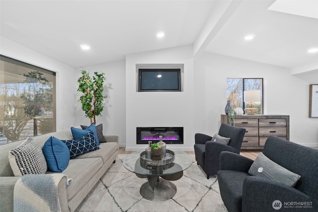 living room featuring a healthy amount of sunlight, lofted ceiling with beams, and light wood-type flooring