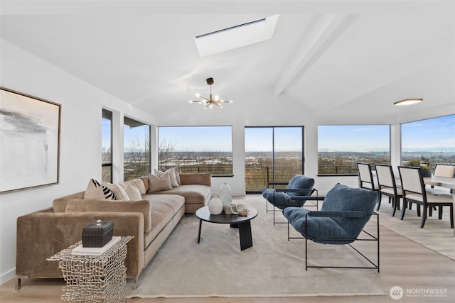 living room with lofted ceiling with skylight, a chandelier, and light wood-type flooring