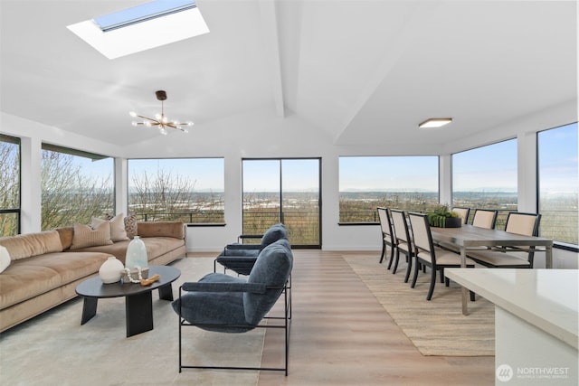 sunroom featuring lofted ceiling with beams, plenty of natural light, and a chandelier