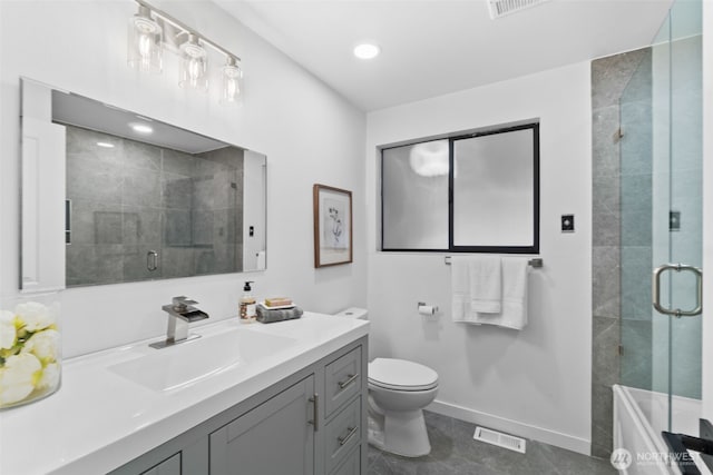 bathroom featuring walk in shower, vanity, and toilet