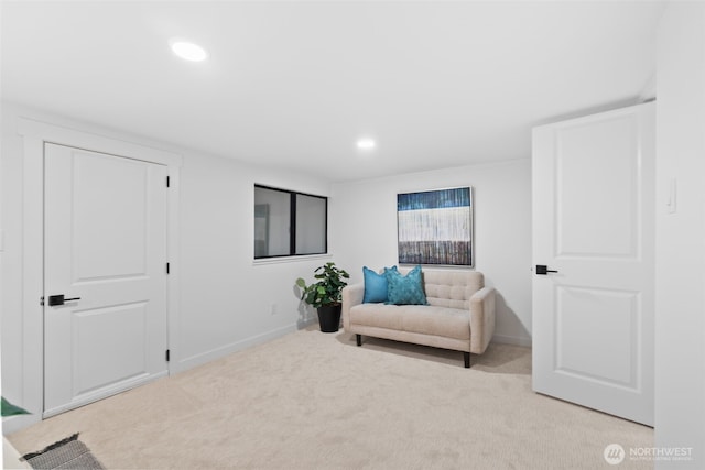 sitting room featuring light carpet