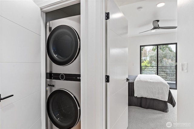 washroom with carpet floors, stacked washer / drying machine, and ceiling fan