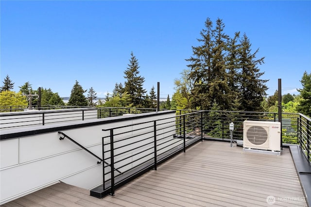 wooden terrace featuring ac unit