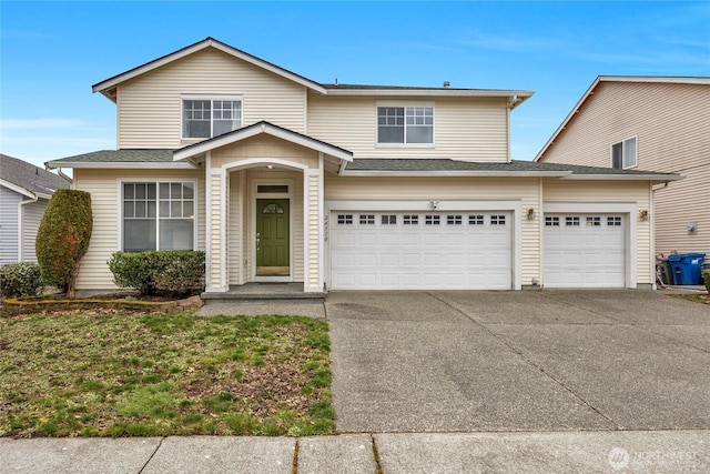 traditional home with driveway and an attached garage