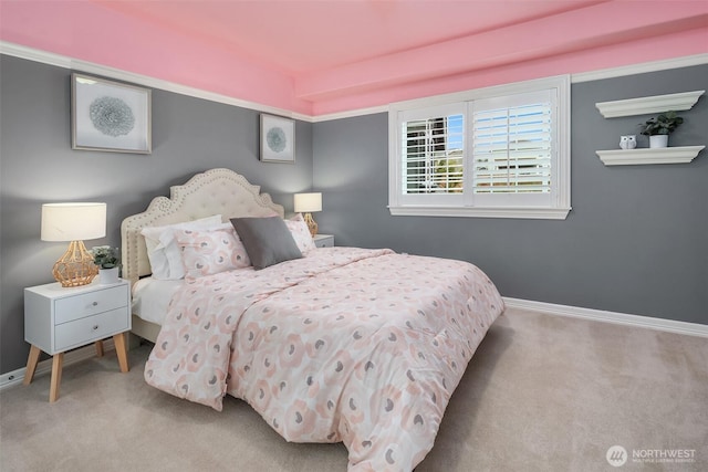 bedroom featuring light carpet and baseboards