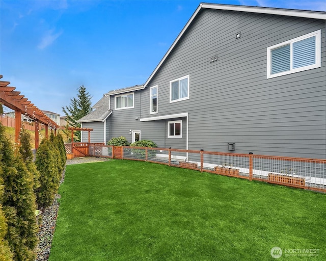 rear view of property with a fenced backyard, a pergola, and a yard