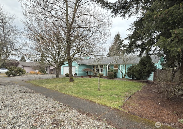 ranch-style home featuring a garage and a front yard