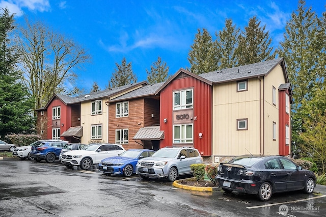 view of property with uncovered parking