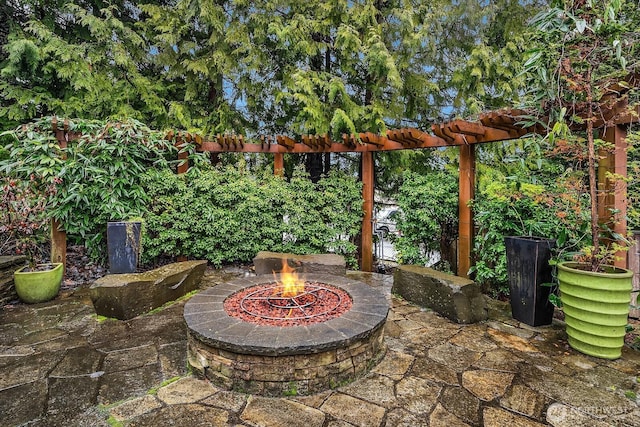 view of patio / terrace featuring an outdoor fire pit