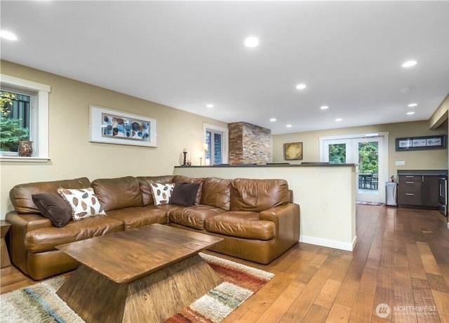 living room with wood finished floors and recessed lighting