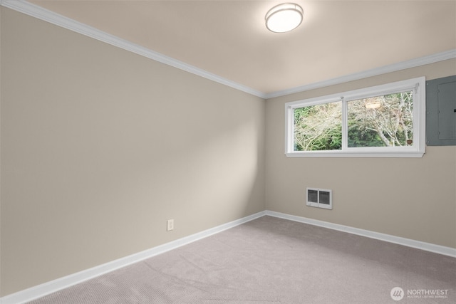 spare room with visible vents, baseboards, electric panel, light carpet, and crown molding