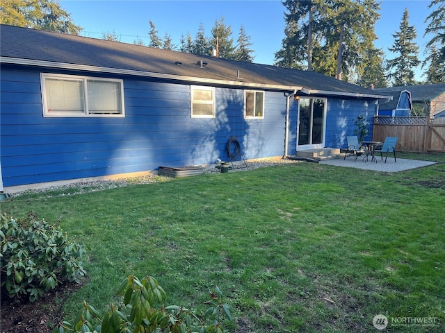 back of property with a patio, fence, and a lawn