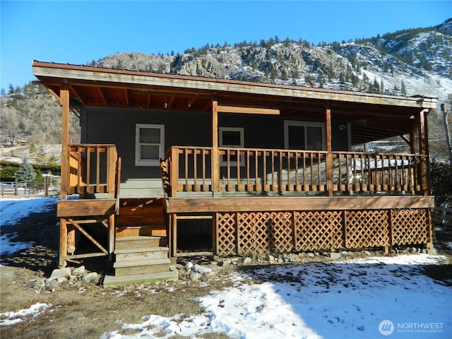 snow covered property featuring a mountain view