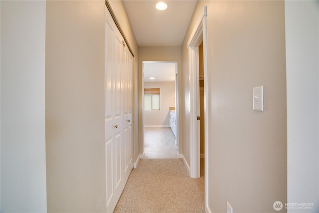 hall with recessed lighting, baseboards, and light colored carpet