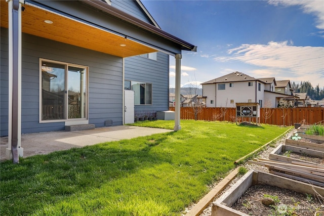 view of yard featuring a garden, a patio area, and fence