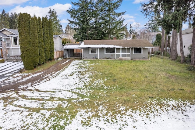 view of front facade with a lawn and a carport