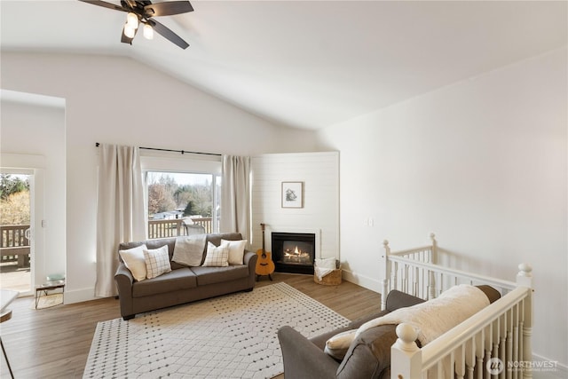 living room with vaulted ceiling, ceiling fan, and hardwood / wood-style flooring