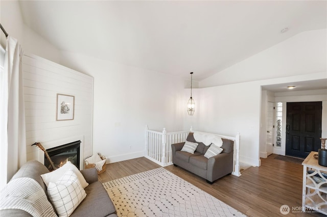 living room featuring vaulted ceiling and wood-type flooring