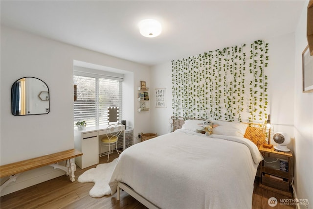 bedroom with wood-type flooring