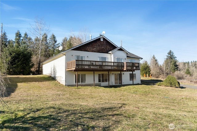 rear view of property featuring a yard and a wooden deck