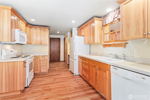 kitchen featuring white appliances, light brown cabinetry, sink, and light hardwood / wood-style flooring