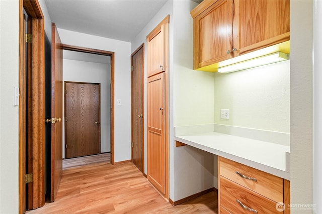 corridor with light hardwood / wood-style floors