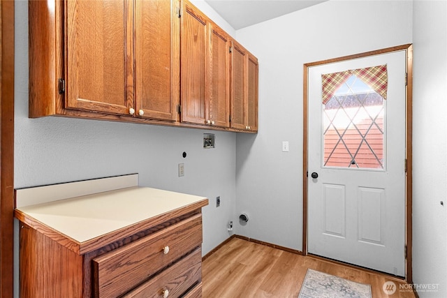 clothes washing area featuring light wood-type flooring, cabinets, hookup for a washing machine, and electric dryer hookup