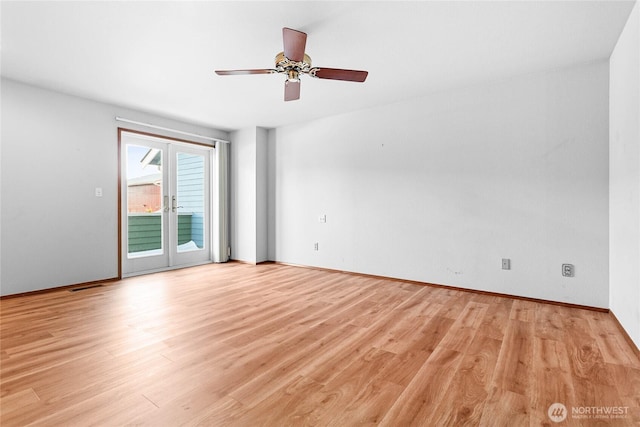 empty room with french doors, ceiling fan, and light hardwood / wood-style floors