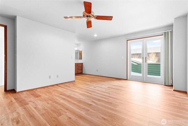 empty room featuring ceiling fan and light wood-type flooring