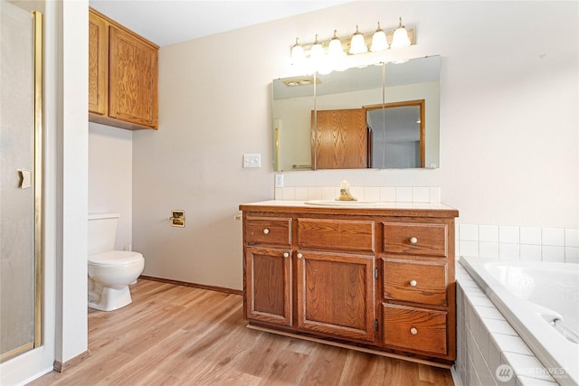 full bathroom with vanity, hardwood / wood-style floors, independent shower and bath, and toilet